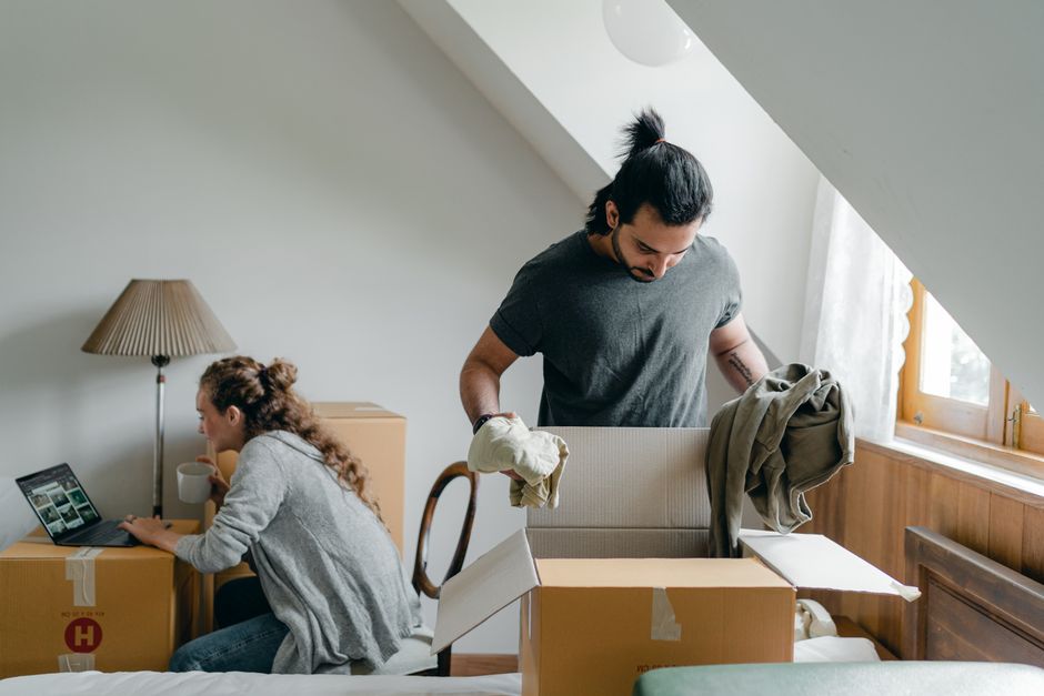 Family unpacking boxes in their new home